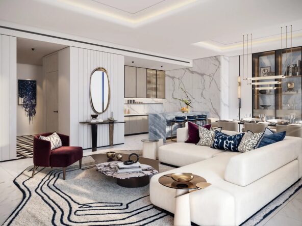 modern and luxurious living room with a white L-shaped sofa, a red armchair, and a marble dining table. The room features a sleek kitchen with a breakfast bar, gold accents, and a statement chandelier.