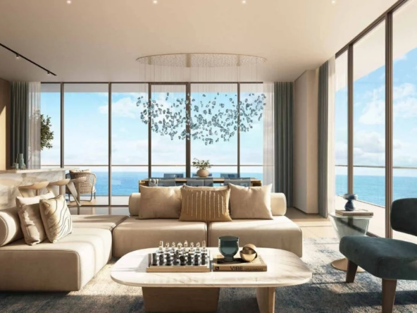 Luxurious beachfront apartment at al marjan Island, showcasing a stunning open-plan living space with floor-to-ceiling windows and ocean vistas