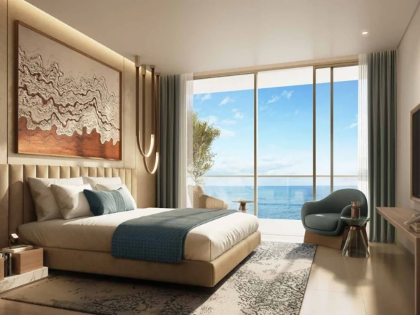 Spacious bedroom in a Damac Shoreline apartment, featuring panoramic ocean views, a king-size bed, and modern decor